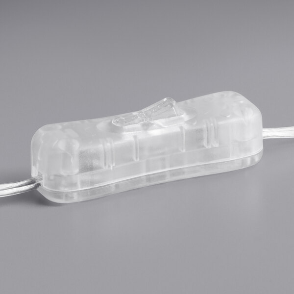 A clear plastic object with a white cord and small handle.