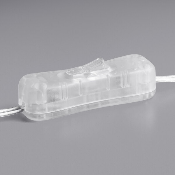 A clear plastic neon sign with red lights that say "Coffee" on a white canvas.