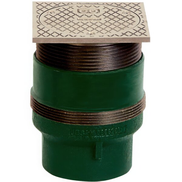 A green pipe with a square metal Josam floor cleanout cover.