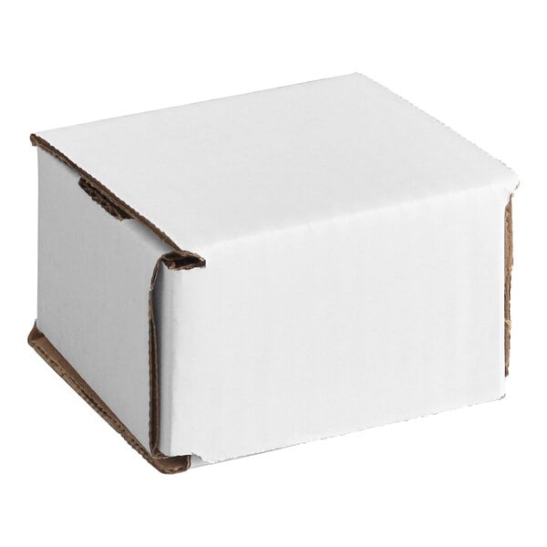 A small white corrugated cardboard mailer box with tuck top flaps.