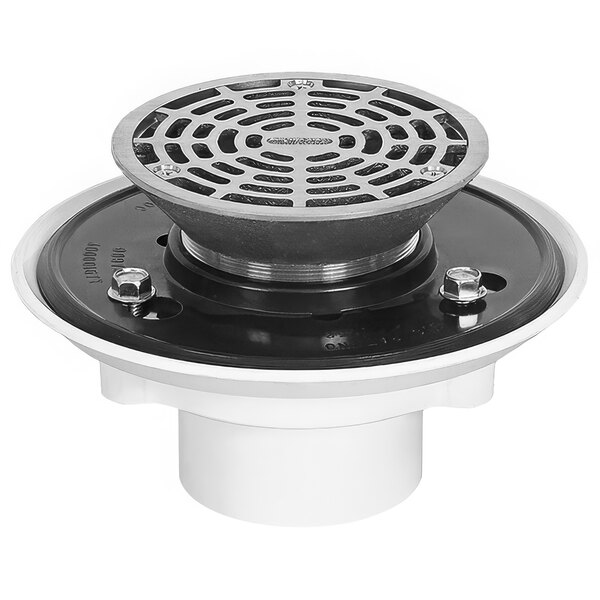 A round metal Josam floor drain with a circular metal strainer with a circular pattern on it.