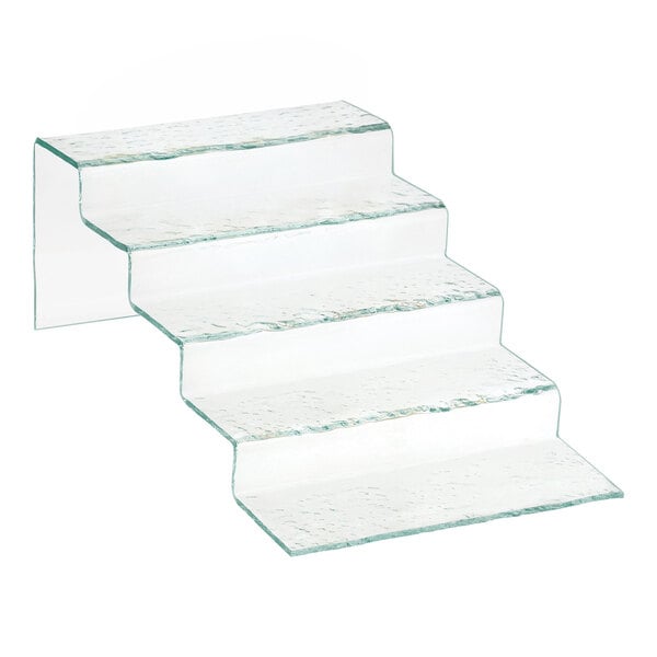 A five-tiered, clear, textured stair-step riser made of faux glass material.