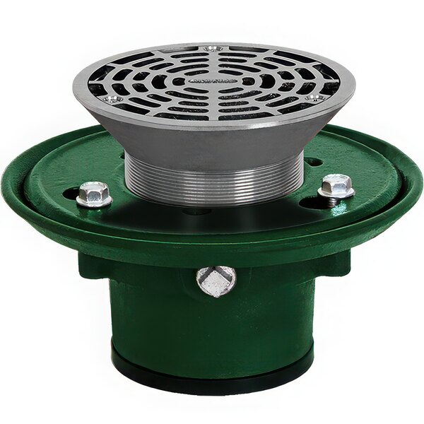 A green and silver round metal Josam floor drain with a hole and metal grate.