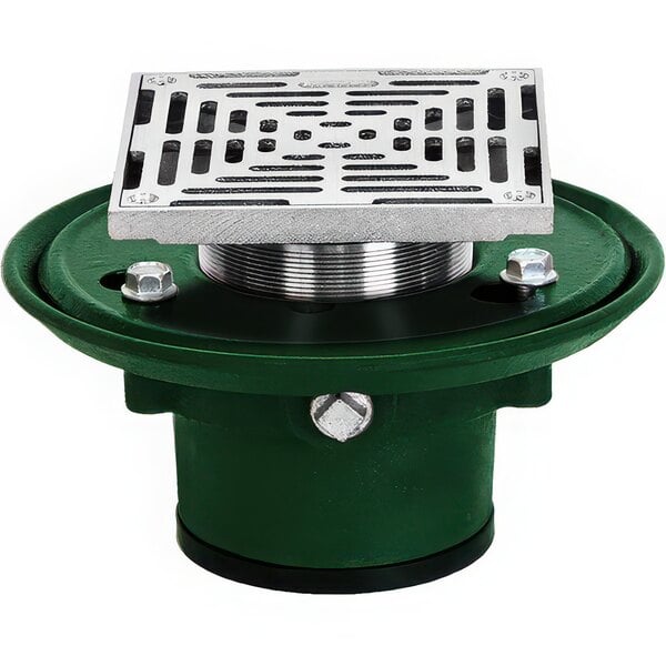 A green and silver metal Josam floor drain with a square metal plate with holes.