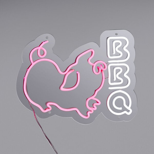 A Canvas Freaks neon sign that says "BBQ" in pink and white with a pig in the middle.