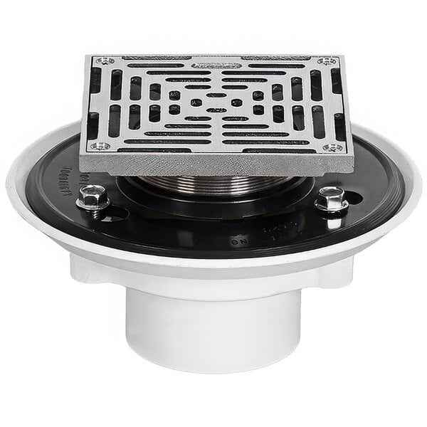 A white Josam adjustable floor drain with a metal Nikaloy strainer over square holes.