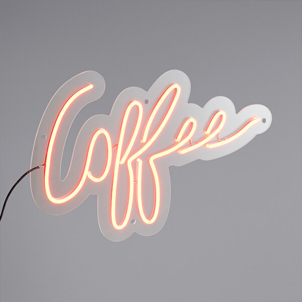 A Canvas Freaks neon sign that says "coffee" in red.