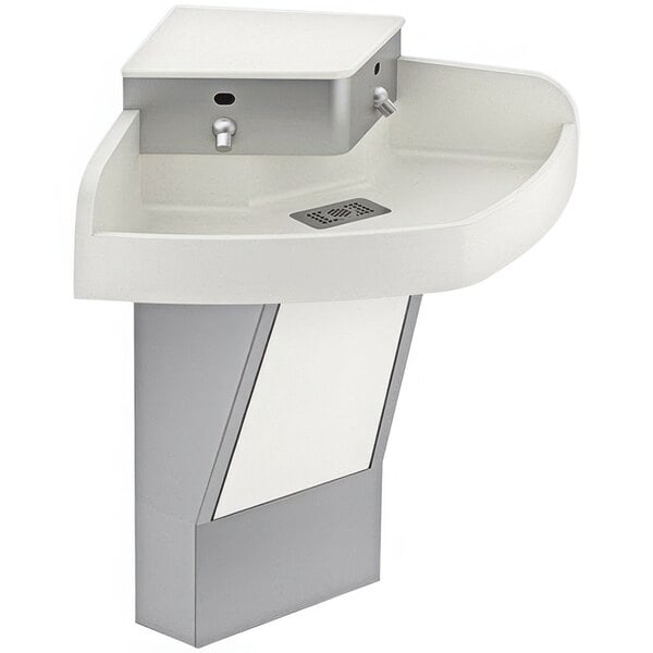A white SloanStone wall mounted hand sink with silver rectangular faucets.