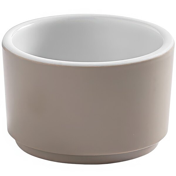 An American Metalcraft white melamine sauce cup with a white rim.