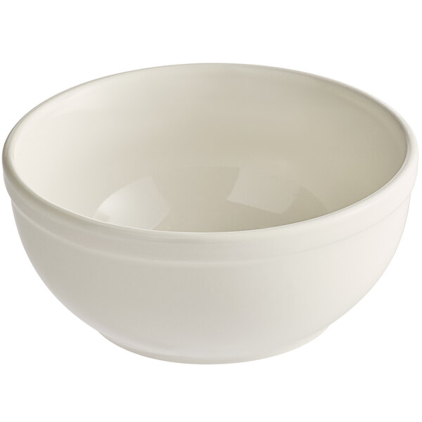 An Acopa ivory stoneware nappie bowl with a rolled edge on a white surface.