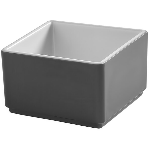 An American Metalcraft Unity square melamine bowl in graphite with a white bottom.