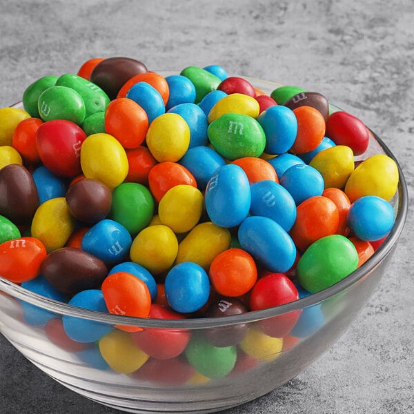 A bowl of M&M's Peanut Milk Chocolate candies on a table.