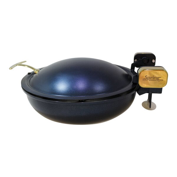 A blue round Spring USA Seasons chafer with gold accents on a counter.