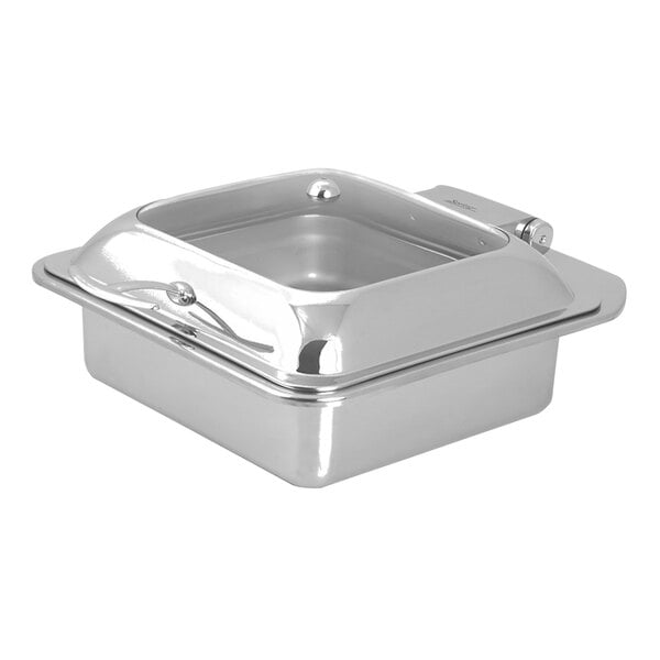 A Spring USA stainless steel square chafer with a glass lid on a silver tray.
