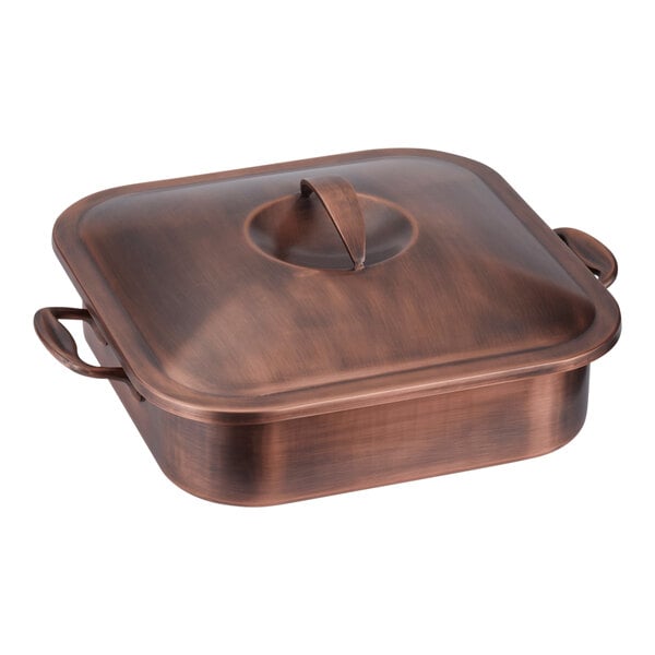 A Spring USA copper chafer with lid on a table.