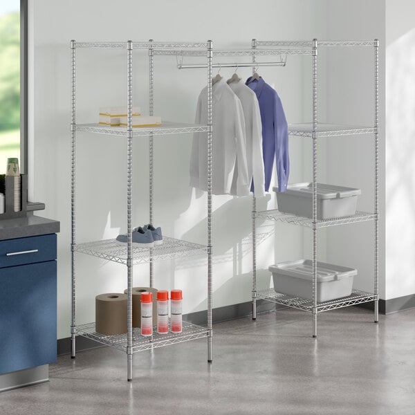 A Regency chrome metal shelving unit with clothes hanging on it.