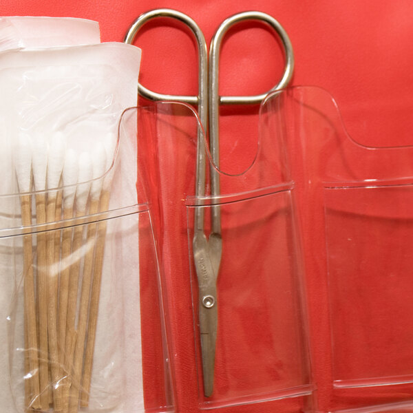 A pair of Medique wire scissors in a clear plastic pocket.