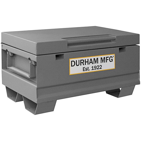 A gray Durham Mfg steel job site box with a white label.