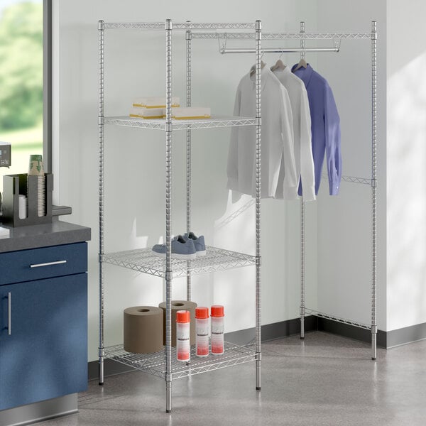 A metal Regency shelving unit with clothes on it.