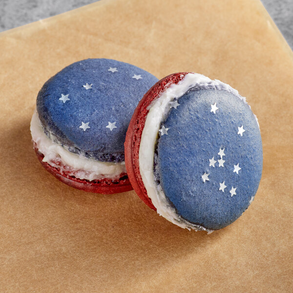 Two Macarons with star designs, one with stars and stripes and the other with twinkling stars.