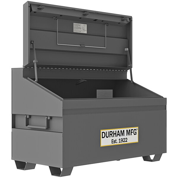 A grey Durham Mfg steel job site box with a white label.