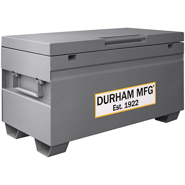 A gray Durham Mfg steel job site box with a white label.
