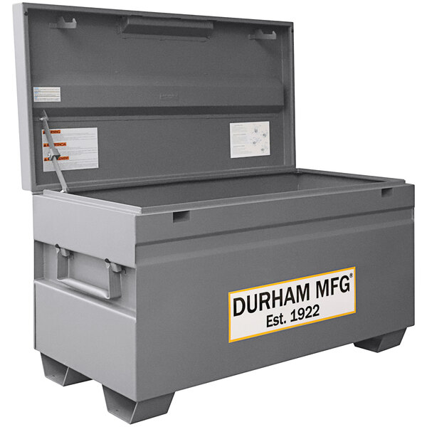 A large gray Durham Mfg steel job site box with a white label.