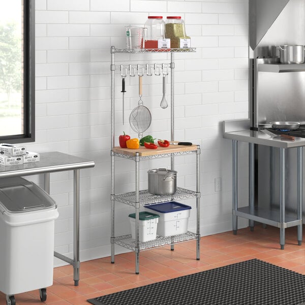 A kitchen with a Regency chrome baker's rack with a hardwood shelf.