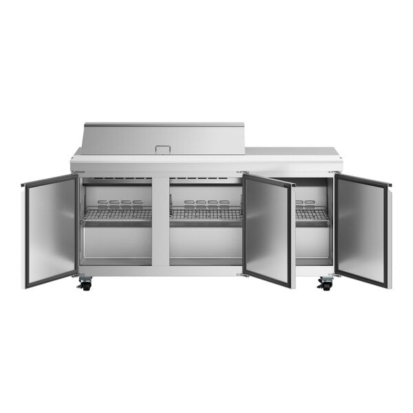 An Avantco stainless steel refrigerator with three doors over a workstation.