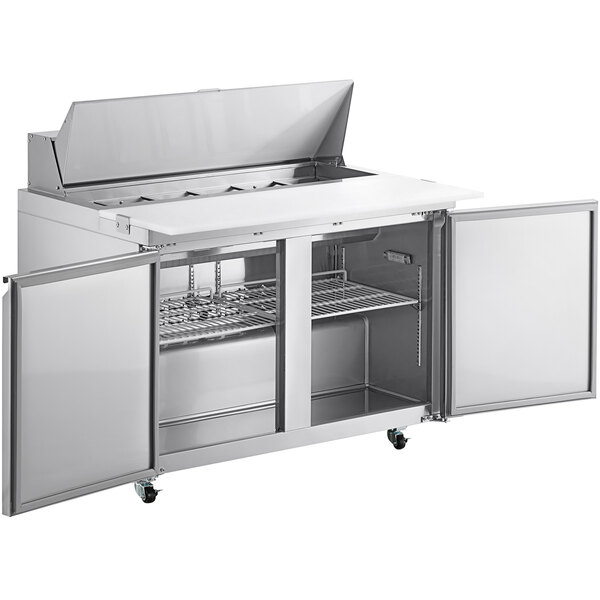 An Avantco stainless steel refrigerator with two doors on a cutting board.