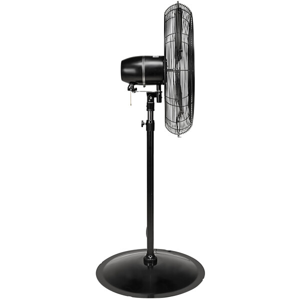 A Tornado black metal pedestal fan on a stand.