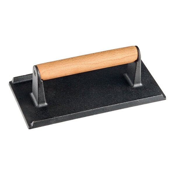 An American Metalcraft black and brown cast iron rectangular steak weight with a wooden handle.
