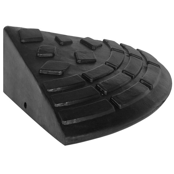 A black rubber object with a triangular design on a white background.