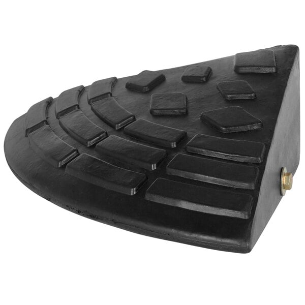 A close up of a black rubber corner ramp with a black edge.
