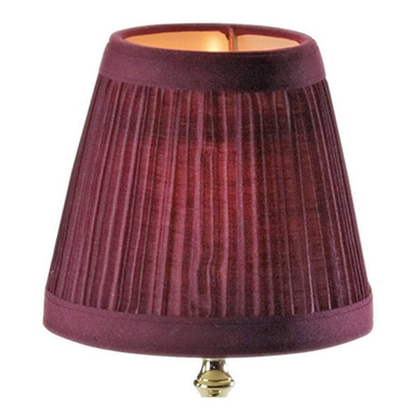 A small, wine-colored, pleated cloth lamp shade with a gold finial at the bottom.