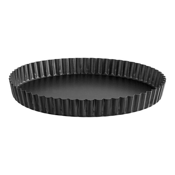 A black round pan with wavy edges.