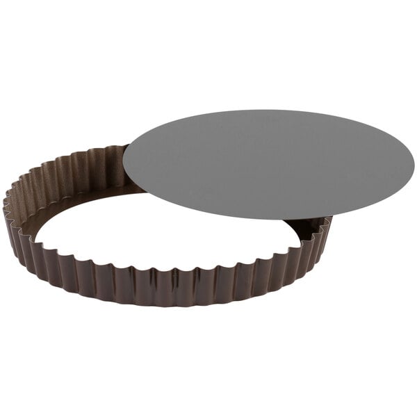 A round grey metal Gobel tart pan with a removable bottom.