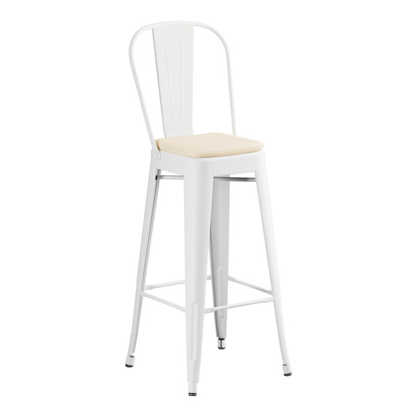 A white Lancaster Table & Seating outdoor cafe barstool with a tan cushion.