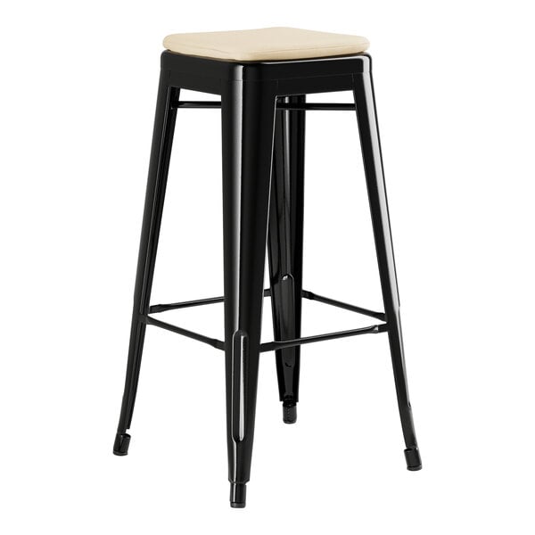 A Lancaster Table & Seating black outdoor bar stool with a tan cushion.