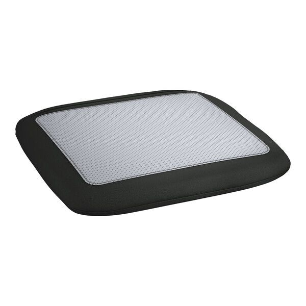 A black cushion with a white patch for a Lancaster Table & Seating outdoor backless counter height stool.