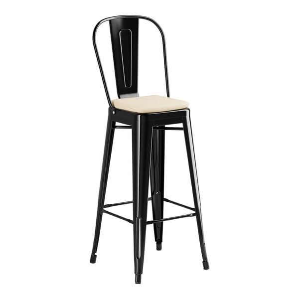 A Lancaster Table & Seating black outdoor restaurant bar stool with tan cushion on a black seat.