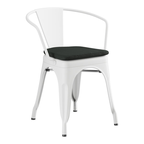 A Lancaster Table & Seating white metal outdoor arm chair with a black cushion.