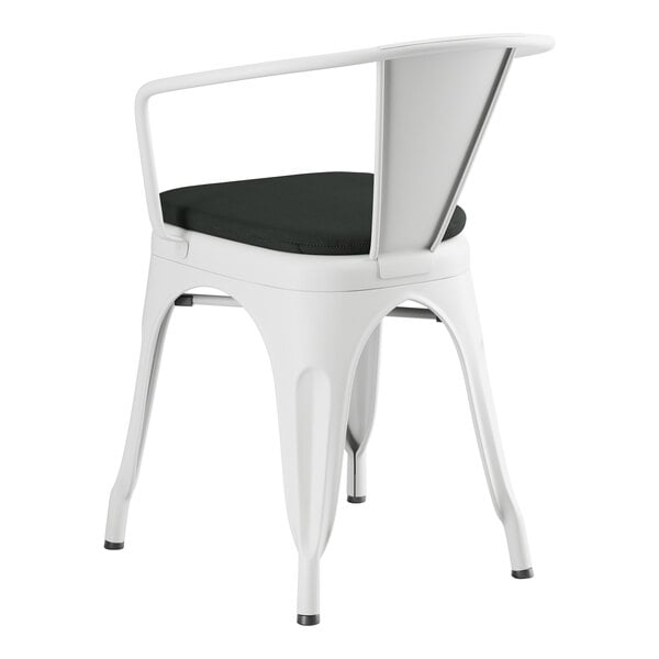 A Lancaster Table & Seating white outdoor arm chair with black cushion.