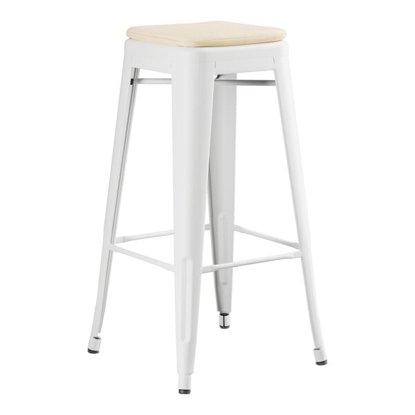 A white Lancaster Table & Seating outdoor backless barstool with a tan cushion.