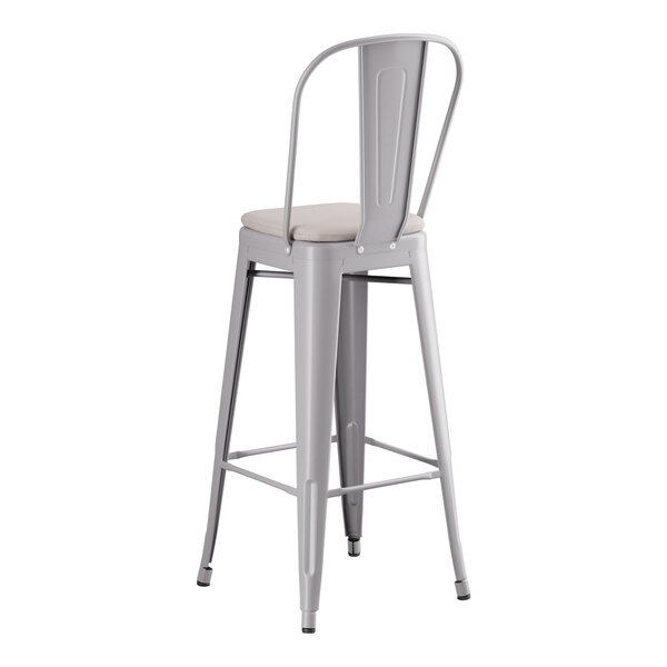A Lancaster Table & Seating gray metal barstool with a gray cushion.
