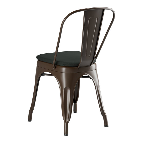 A brown metal Lancaster Table & Seating outdoor cafe chair with a black cushion.