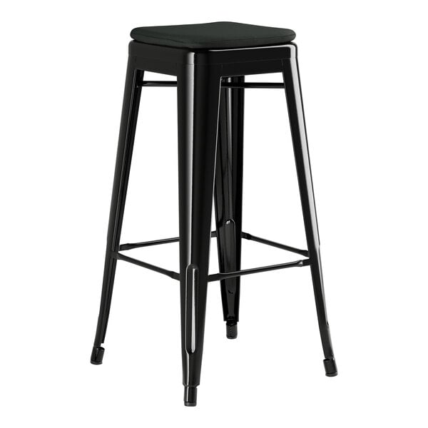 A Lancaster Table & Seating black metal outdoor backless bar stool with a black cushion.