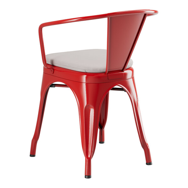 A red Lancaster Table & Seating outdoor arm chair with a gray cushion.