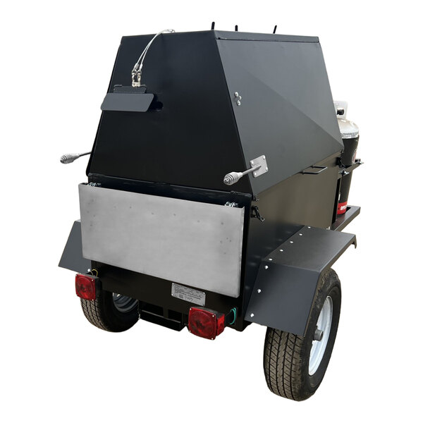 A large black towable propane grill with a stainless steel rotisserie attachment and dual wheels.