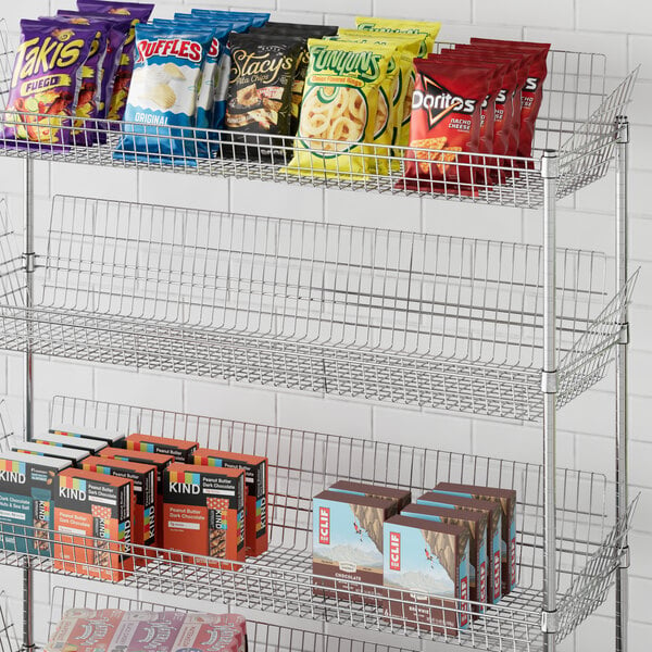 A metal Regency display shelf with snacks and chips on it.